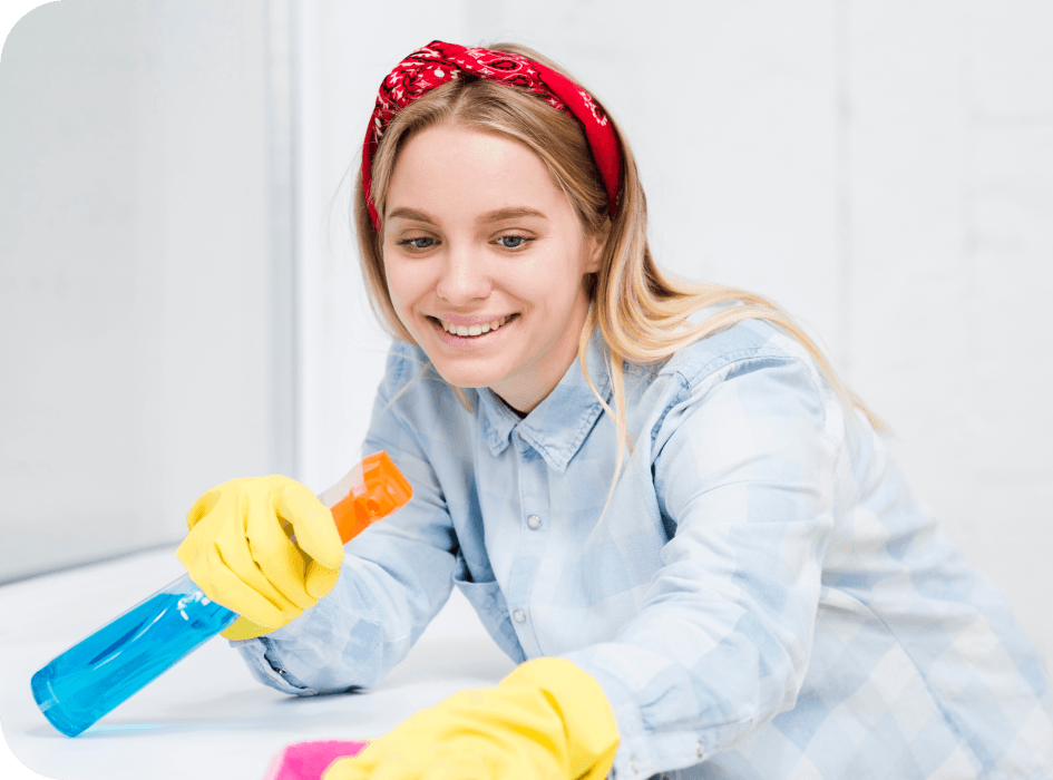 A lady cleaning with a smile on her face